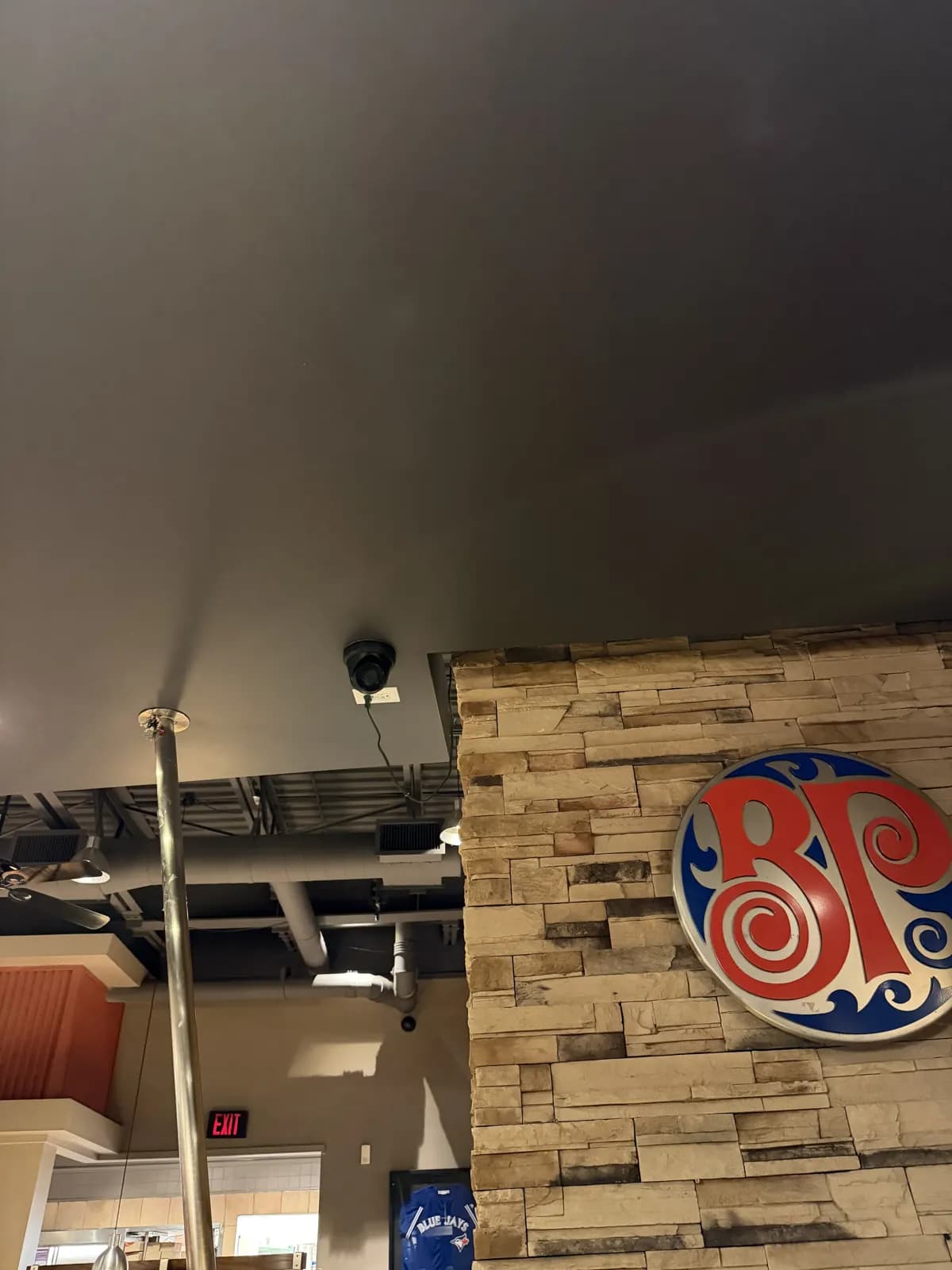 Ceiling-mounted security camera inside a Boston Pizza restaurant